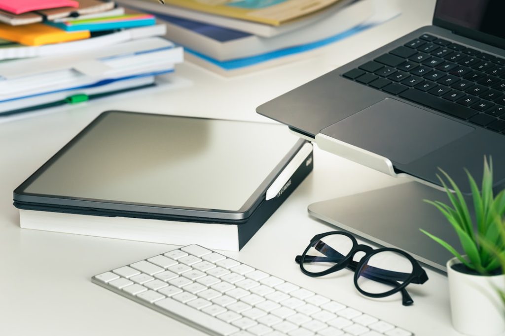 Laptop and printed materials arranged on a desk